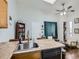 Open floor plan with tile countertops, open shelving, dining table, and an adjoining seating area at 962 S Dearborn Way # 19, Aurora, CO 80012