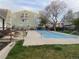 View of the fenced pool area showing pool cover and exterior of condo buildings at 962 S Dearborn Way # 19, Aurora, CO 80012