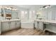 Bright bathroom with a soaking tub, double vanities and modern fixtures at 6071 Russell Ln, Arvada, CO 80403