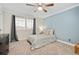 Comfortable bedroom with a ceiling fan, neutral color palette and plantation shutters at 6071 Russell Ln, Arvada, CO 80403