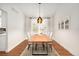 Modern dining room featuring a large wooden table, stylish lighting, and bright natural light at 6071 Russell Ln, Arvada, CO 80403