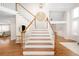 Grand foyer with high ceilings, hardwood floors, and an elegant staircase with white railings at 6071 Russell Ln, Arvada, CO 80403