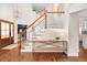 Bright foyer featuring hardwood floors, a staircase, and ample natural light from large windows at 6071 Russell Ln, Arvada, CO 80403