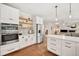 Modern kitchen with stainless steel appliances, hardwood floors, and open to the living area at 6071 Russell Ln, Arvada, CO 80403