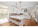 Modern kitchen with quartz counters, stainless appliances, and breakfast bar seating at 6071 Russell Ln, Arvada, CO 80403