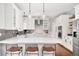 Modern kitchen boasts quartz counters, stainless appliances, and pendant lighting at 6071 Russell Ln, Arvada, CO 80403