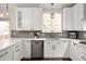 Bright kitchen with stainless appliances, quartz counters, and white cabinetry at 6071 Russell Ln, Arvada, CO 80403