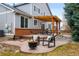 Inviting backyard patio with fire pit, pergola, and comfortable seating, perfect for outdoor gatherings at 6071 Russell Ln, Arvada, CO 80403