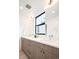 Bathroom features modern lighting, double sinks and vanity with stylish mirror at 3433 Lawrence St # 1, Denver, CO 80205