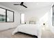 Bright bedroom features modern ceiling fan, large windows and stylish furnishings at 3433 Lawrence St # 1, Denver, CO 80205