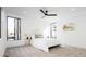 Bright bedroom featuring modern ceiling fan, large windows and neutral interior design at 3433 Lawrence St # 1, Denver, CO 80205