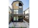 Modern three-story home with a black metal exterior and a small balcony at 3433 Lawrence St # 1, Denver, CO 80205