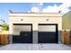 Detached two-car garage with black doors at 3433 Lawrence St # 1, Denver, CO 80205