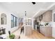 Modern kitchen features stainless appliances, a kitchen island, and bright natural light at 3433 Lawrence St # 1, Denver, CO 80205