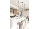 Kitchen island featuring seating, modern lighting, and stainless appliances at 3433 Lawrence St # 1, Denver, CO 80205