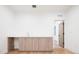 Room featuring a wet bar with wood cabinets, white countertops, and a stainless steel faucet at 3433 Lawrence St # 1, Denver, CO 80205
