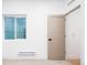 Bright room featuring a window, neutral carpet, and a tan interior door at 3433 Lawrence St # 1, Denver, CO 80205