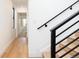 Modern staircase with black railing and light wood stairs at 3433 Lawrence St # 1, Denver, CO 80205