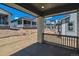 Covered back porch with view of neighbor homes and landscaping; ready for personalization at 8241 Rockvale Dr, Littleton, CO 80125