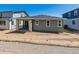 Exterior view of home showcasing sliding glass door and space for landscaping at 8241 Rockvale Dr, Littleton, CO 80125
