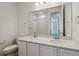 Bathroom featuring a double vanity, large mirror, and tiled shower at 8241 Rockvale Dr, Littleton, CO 80125