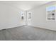 A carpeted bedroom with two windows and white walls; excellent natural light at 8241 Rockvale Dr, Littleton, CO 80125