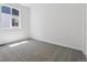 A large carpeted bedroom features a light grey carpet and a bright window at 8241 Rockvale Dr, Littleton, CO 80125