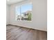 Sun-filled bedroom with expansive windows and warm-toned hardwood floors at 8241 Rockvale Dr, Littleton, CO 80125
