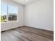 Bright bedroom featuring large windows and stylish, neutral-toned hardwood flooring at 8241 Rockvale Dr, Littleton, CO 80125