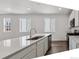 Modern kitchen with an island, stainless steel appliances, and hardwood floors at 8241 Rockvale Dr, Littleton, CO 80125