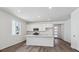 Bright kitchen featuring an island, stainless steel appliances, and hardwood floors at 8241 Rockvale Dr, Littleton, CO 80125