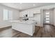 Modern kitchen boasting a large island, stainless steel appliances, and sleek hardwood floors at 8241 Rockvale Dr, Littleton, CO 80125