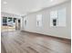 Open-concept living room with large windows, hardwood floors, and a bright atmosphere at 8241 Rockvale Dr, Littleton, CO 80125