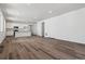 Bright, open-concept living room and kitchen area with modern white cabinets at 8241 Rockvale Dr, Littleton, CO 80125