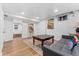 Finished basement featuring a decorative rug, gray sofa, and painted white brick at 2339 Lowell Blvd, Denver, CO 80211