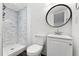 Updated bathroom with white marble tiling, walk-in shower, modern sink and fixtures at 2339 Lowell Blvd, Denver, CO 80211