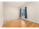 Neutral bedroom featuring wood floors, a window with curtains, and natural light at 2339 Lowell Blvd, Denver, CO 80211