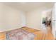A simple bedroom with hardwood floors, light walls, and an open doorway to another room at 2339 Lowell Blvd, Denver, CO 80211