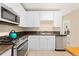Bright kitchen features stainless steel appliances, granite countertops, and white cabinetry at 2339 Lowell Blvd, Denver, CO 80211