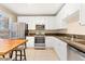 The bright kitchen has stainless steel appliances, granite countertops, and tiled flooring at 2339 Lowell Blvd, Denver, CO 80211