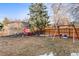 Large backyard featuring a wooden fence, a swing set, and a red chicken coop at 6532 S Ogden St, Centennial, CO 80121