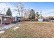 The backyard features a patio with outdoor seating, a grill, and a spacious lawn area perfect for entertaining at 6532 S Ogden St, Centennial, CO 80121