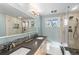 Bright bathroom with double sinks, modern fixtures, and a glass-enclosed shower at 6532 S Ogden St, Centennial, CO 80121