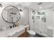 Modern bathroom featuring a new glass shower, a floating vanity, and ample lighting at 6532 S Ogden St, Centennial, CO 80121