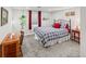 Bedroom with a plaid comforter, red accents, and natural light from two windows at 6532 S Ogden St, Centennial, CO 80121