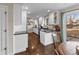 Modern kitchen with white cabinets, stainless steel appliances, granite countertops, and hardwood floors at 6532 S Ogden St, Centennial, CO 80121