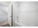 Clean bathroom with tub, shower, and white tile at 16142 E 111Th Dr, Commerce City, CO 80022