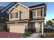 Two-story house with beige siding, large windows, and a two-car garage. Under construction at 16142 E 111Th Dr, Commerce City, CO 80022