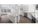 Modern kitchen with white cabinets, granite countertops, and an island at 16142 E 111Th Dr, Commerce City, CO 80022