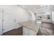 Modern kitchen with white cabinets, granite countertops, and an island at 16142 E 111Th Dr, Commerce City, CO 80022